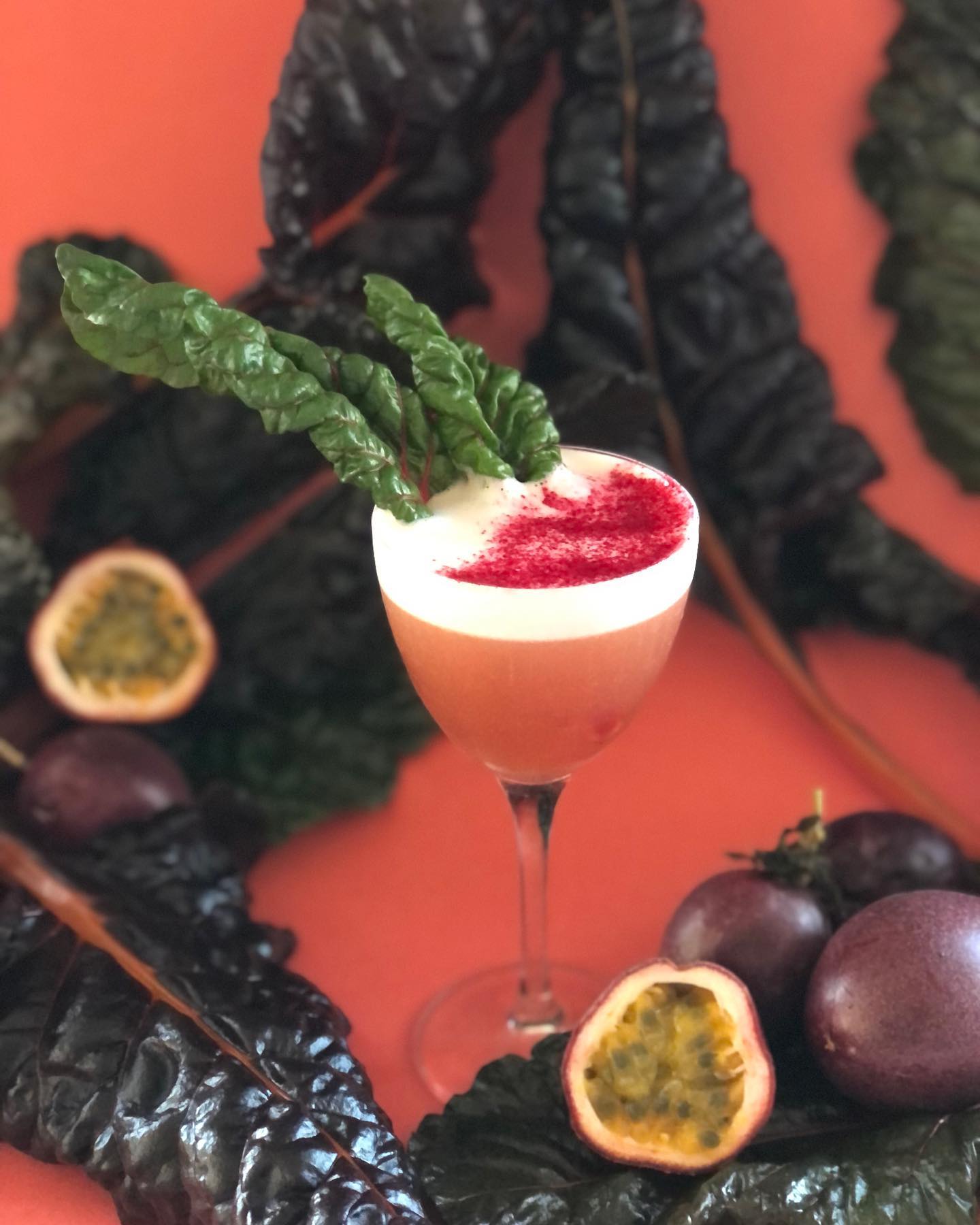Passionfruit sour with chard leaf and red dust